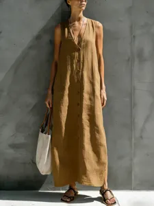 Close-up detail of sleeveless V-neck button-down cotton linen long dress in camel color.