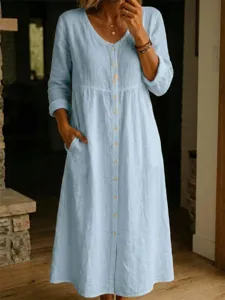 Light blue cotton linen maxi dress detail, long sleeves, front buttons, and convenient pockets.