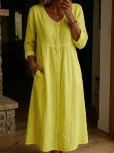 Detailed view of women's long sleeve V-neck button down linen dress with side pockets.