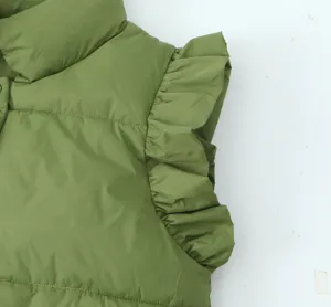 Close up view of the olive green quilted vest showing detailed ruffled shoulder and high collar.