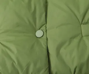 Green padded cotton vest detail featuring snap button closure and quilted design style.