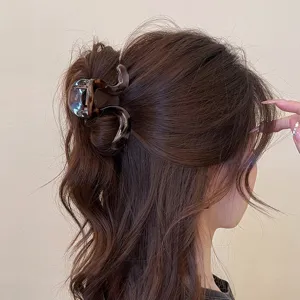 Elegante molletta per capelli tartarugata, design ondulato per acconciature alla moda.