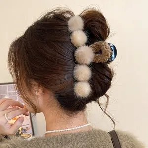Fluffy plush hair claw clip for women, large autumn and winter hair styling accessory.