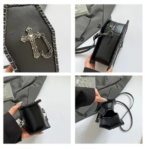 Detailed view of gothic coffin crossbody bag, vintage floral cross ornament, metal chain.
