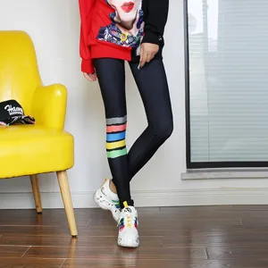 Stylish black women's leggings with vibrant colorful stripes, slim fit for casual daily wear.