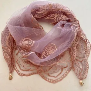 Detailed view of women lightweight embroidered rose triangle scarf with elegant lace edge and gold charms.