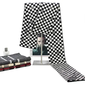 Classic black and white checkerboard knitted scarf for winter warmth, stylish unisex apparel.