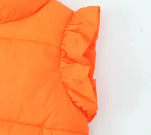 Close up view of bright orange winter vest detail, featuring stylish ruffle flutter sleeves.