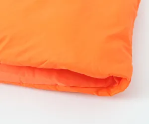 Detailed view of the vibrant orange quilted puffer cotton vest fabric, showcasing soft texture.