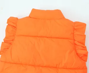 Orange puffer vest detail, stand collar and chic ruffle sleeves for women winter fashion style.