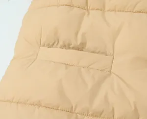 Close-up detail of womens winter quilted puffer vest fabric and pocket design, warm casual wear.
