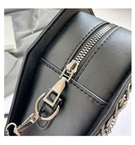 Black gothic crossbody bag detail shot, PU leather shoulder bag with metal zipper and chain.