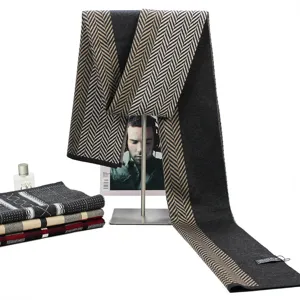 Detailed view of thick knit winter wool scarf with classic herringbone pattern and soft texture.