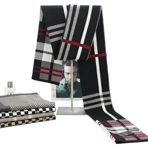 Detailed winter plaid scarf in black white red, showing soft fabric and fringe view.
