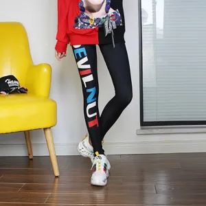 Women black skinny leggings with colorful letter print, stretchy slim fit casual pants.