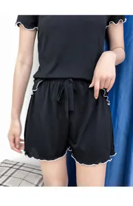 Black lettuce trim short sleeve pajama set detail, showing ribbed fabric and sweet ruffle edge.