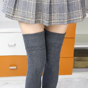 Autumn winter Japanese style cable knit over knee socks with grey plaid pleated skirt outfit.