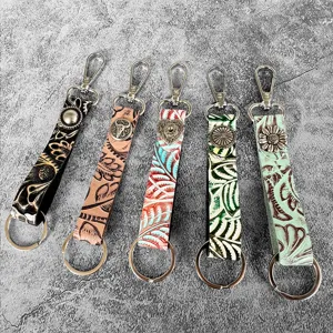 Detail view of vintage western genuine leather embossed keychains in multi colors for bags.