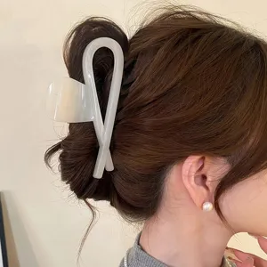 Nahaufnahme der minimalistischen cremeweißen Acryl Haarklammer mit elegantem Textur und Design.