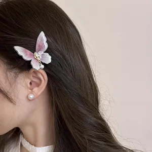Detailed close-up view of the pink gradient butterfly hair clip with cute pearl pendant.
