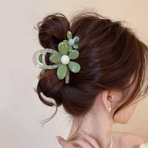 Green flower hair claw clip detail shot, elegant acrylic hair accessory for women styling.