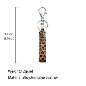 Leopard print genuine leather keychain detail showing size, alloy ring and flower button accent