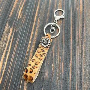 Leopard print hair-on leather keychain with sunflower charm western bag charm accessory.