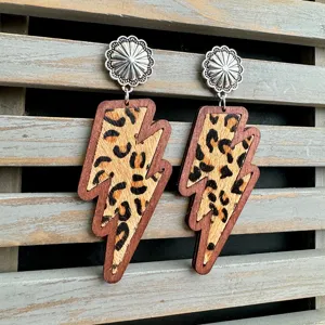 Detailed close-up shot of western style wooden leopard print lightning bolt dangle earrings.
