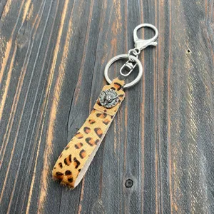 Leopard print calf hair keychain detail view with vintage metal bull skull charm accessory