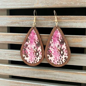 Vintage wooden teardrop earrings with pink cow print pattern, stylish western jewelry for women.