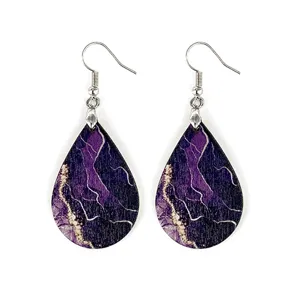 Detailed view of lightweight bohemian wooden teardrop earrings with purple marble print.