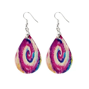 Detail view of lightweight wooden teardrop earrings with colorful bohemian tie-dye swirl design.