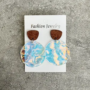 Wooden acrylic drop earrings featuring holographic wave pendants for trendy summer fashion looks.