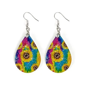 Close-up detail of lightweight wooden teardrop earrings with vibrant colorful sunflower print design.