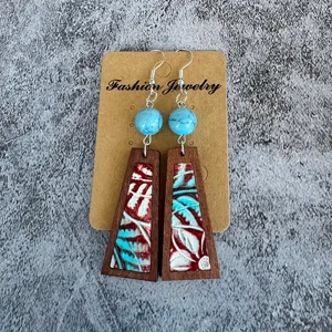 Vintage wood dangle earrings with turquoise beads and tooled floral leather inlay for women.
