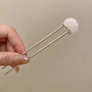 Detailed view of the elegant Chinese style U-shaped hair fork with white marbled top.