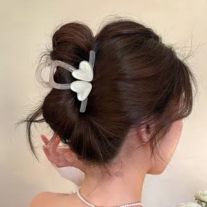 Detailansicht einer minimalistischen transparenten Haarklammer mit süßen Herzen.
