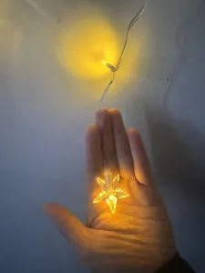 LED star string light detail shot, warm yellow glow, ideal for holiday and party decor.