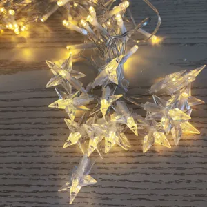 Close-up detail of warm white LED starry string lights with transparent star shades for decor.