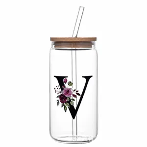 Clear glass can with bamboo lid and straw, floral letter V design, perfect for iced coffee.