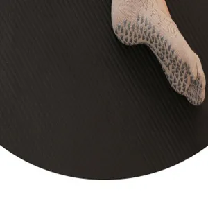 Close-up view of beige five-toe yoga socks with grey anti-slip grip dots for Pilates.