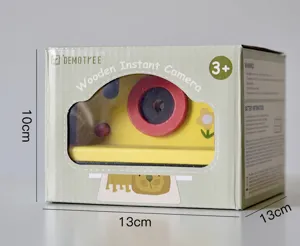 Close up detail of wooden instant camera toy packaging box with cute animal design.