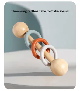 Wooden baby rattle toy with three colorful rings for early childhood musical development.