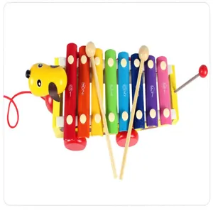 Wooden pull-along dog xylophone detail showing colorful keys and mallets for early music toy.