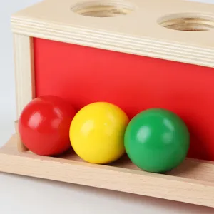 Wooden pounding bench toy with colorful balls for early education and hand-eye coordination.
