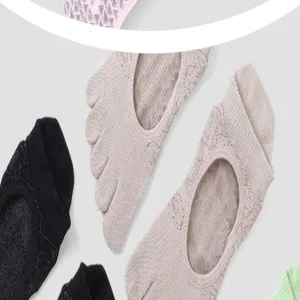 Detailed view of women five-toe yoga socks, non-slip grip design for pilates and fitness.