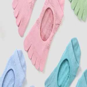 Close up view of multi-color five toe yoga socks, breathable fabric for pilates workout.