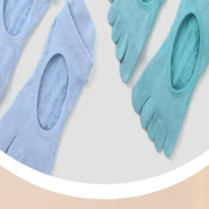 Close-up of breathable five-toe yoga socks, non-slip pilates athletic grip footwear detail.