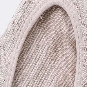 Detailed view of the knit yoga sock, showing fine texture and soft beige binding edge.