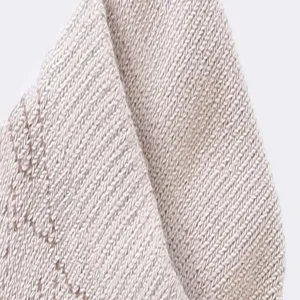 Detail view of premium cotton knit fabric texture, soft breathable material for comfort.
